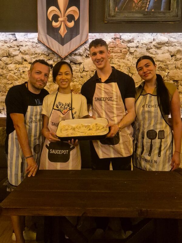Happy guests posing with their handmade burek at Burek Masterclass
