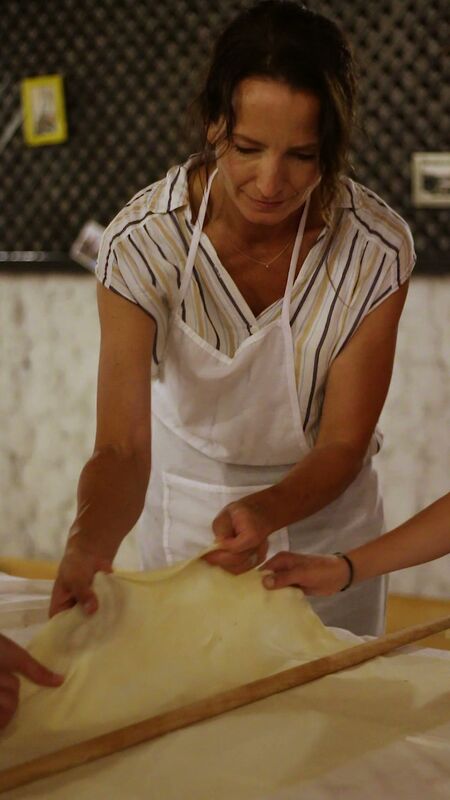 Guest stretching thin burek dough