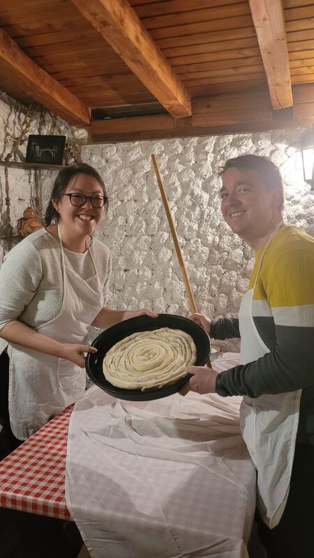 Couple holding a freshly rolled burek spiral